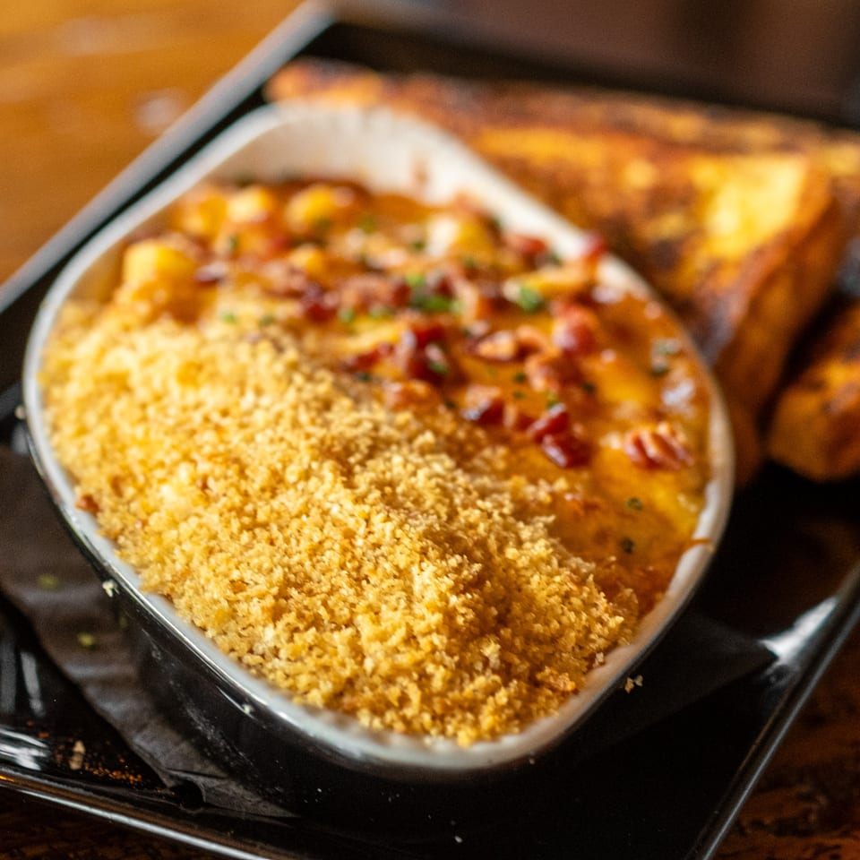 Dea's In & Out mac and cheese with breadcrumbs and bacon, served with toast.