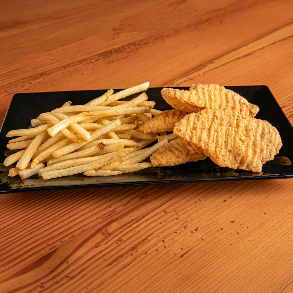 Dea's In & Out chicken tenders and french fries on a black rectangular plate.